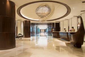 a lobby with a large chandelier and a hotel at Sedona Hotel Yangon in Yangon