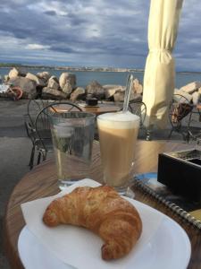 a plate with a pastry and a drink on a table at Apartment Nikolina in Piran