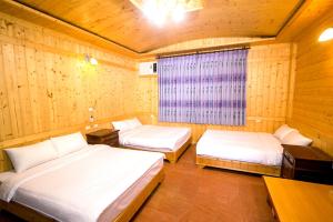 Postel nebo postele na pokoji v ubytování Yi Xin Homestay