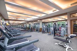 a gym with a row of treadmills and machines at Wyndham Beijing North in Changping