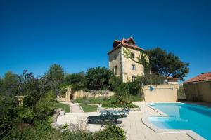 a building with a pool in front of a house at Maison Tranquil in Bellegarde-du-Razès