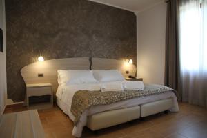 a bedroom with a large bed with two white pillows at Monte San Giovanni-Nebrodi Rooms in San Marco dʼAlunzio