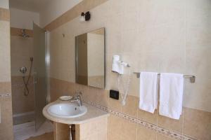 a bathroom with a sink and a mirror and towels at Monte San Giovanni-Nebrodi Rooms in San Marco dʼAlunzio +56 photos