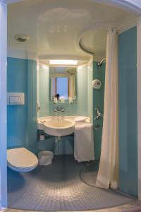 a bathroom with a sink and a toilet at Hotel Reseda in Bagnolet