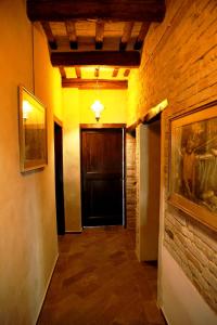 einen Flur mit einer Tür und einem Gemälde an der Wand in der Unterkunft B&B Mik e Ramo in Abbadia di Fiastra