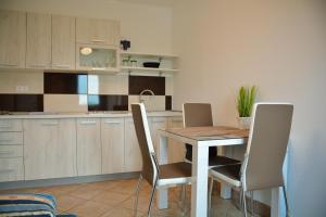 a kitchen with a wooden table and chairs at Farm Stay Zevnik in Brežice