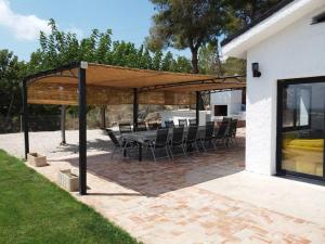 a patio with a table and chairs under a pavilion at Casa Carmen in Alcanar
