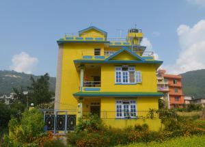 a yellow house with a tower on top of it at Dahachok Homestay in Dahachok +23 photos
