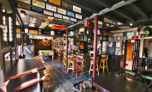 a bar with tables and chairs in a restaurant at The Parkway Hotel in Dunmanway