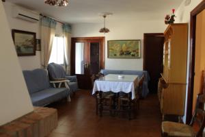 イゲラ・デ・ラ・シエラにあるCasa Rural El Tejarのリビングルーム(テーブル、椅子付)