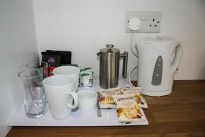 a tray with cups and other items on a table at Bex Rooms in Worthing