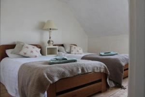 una camera con due letti e asciugamani di Snowdrop Cottage a Gloucester