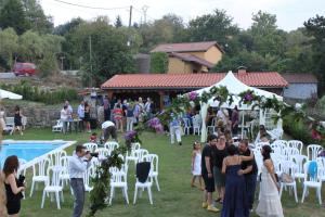 a group of people standing in front of a wedding ceremony at Posada La Estela Cántabra in Toñanes +56 photos