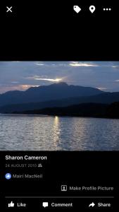 a screenshot of a phone screen with a picture of a lake at Brackenbrae Holiday Cottage in Acharacle