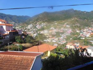 a view of a town on a hill with houses at Marques House in Machico