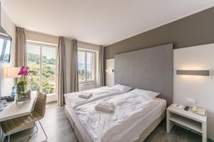 Postel nebo postele na pokoji v ubytování Hôtel Prealpina
