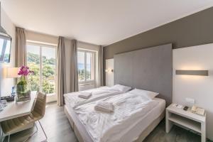 Un pat sau paturi într-o cameră la Prealpina