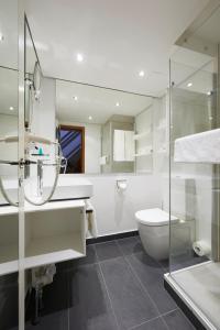 
a bathroom with a toilet, sink, and bathtub at Hotel Schloss Eckberg in Dresden
