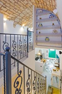 a staircase in a house with blue and white at Tholos Deluxe House in Astypalaia Town