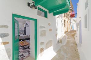 a doorway to a house with a green door at Tholos Deluxe House in Astypalaia