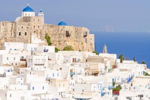 a group of white buildings on the side of a mountain at Tholos Deluxe House in Astypalaia Town