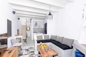 a living room with a couch and a table at Tholos Deluxe House in Astypalaia Town