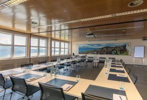 a large room with tables and chairs and a painting at Prealpina in Chexbres