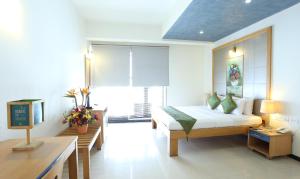 Letto o letti in una camera di Treebo Edha Suites Koramangala