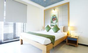 Letto o letti in una camera di Treebo Edha Suites Koramangala