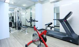 a gym with a treadmill and an exercise bike at Treebo Trend Edha Suites Koramangala in Bangalore