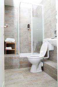 a bathroom with a toilet and a shower at Main Hotel Frankfurt City in Frankfurt