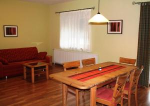 a living room with a wooden table and a couch at Ferienhof Weingut Lunzer in Gols