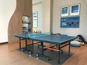 a ping pong table in the middle of a room at Baan Kiang Fah By Greenday in Hua Hin