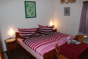 a bedroom with a large bed and a table at Rudighof in Pettneu am Arlberg