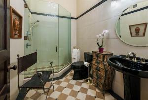a bathroom with a glass shower and a sink at The Inn at 97 Winder in Detroit