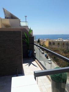 a balcony of a building with a view of a street at SEAVIEW Marsascala Apartment in Marsaskala