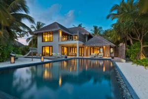 a villa with a swimming pool in front of it at Dusit Thani Maldives in Baa Atoll