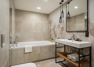 a bathroom with a tub and a sink at Biała Owca in Zakopane