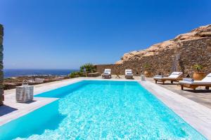 a swimming pool with a view of the ocean at Elia Sea View Luxury Villa in Elia Beach
