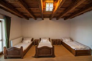 a room with two beds and two chairs at Zsirai Guest House in Mád