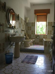 a bathroom with two sinks and two toilets at Villa Spaia in Brancaleone Marina