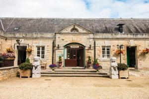 an old stone building with statues in front of it at Normanton Park Hotel, Sure Hotel Collection by Best Western in Oakham