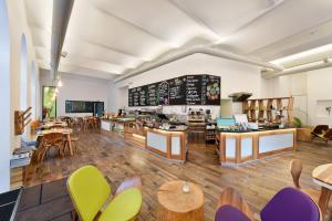 a restaurant with wooden floors and tables and chairs at Hotel Mocca in Vienna