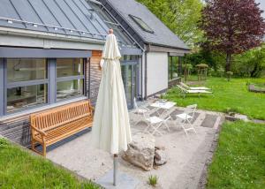 a white umbrella sitting in a yard next to a house at Feriendomizil M No_ 7_1 in Villingen-Schwenningen