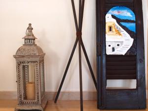 a lamp and a lantern next to a door at Smaragdi in Perivolos