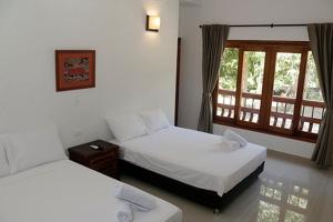 Postel nebo postele na pokoji v ubytování Finca Hotel Guali Santafe