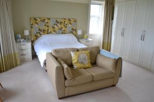 a living room with a couch and a bed at Burnside Farm B & B in Girvan