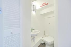 a white bathroom with a sink and a toilet at Artist Studio - By My Getaways in Brighton & Hove