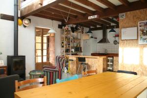 a dining room with a wooden table and chairs at Albergue Les Xendes. Parque de Redes in Caso