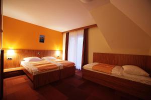 Postel nebo postele na pokoji v ubytování Hotel Marinšek